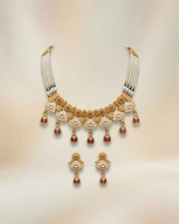 Gold kundan meenakari choker necklace and drop earrings set — white enamel lotus motif with ruby accents