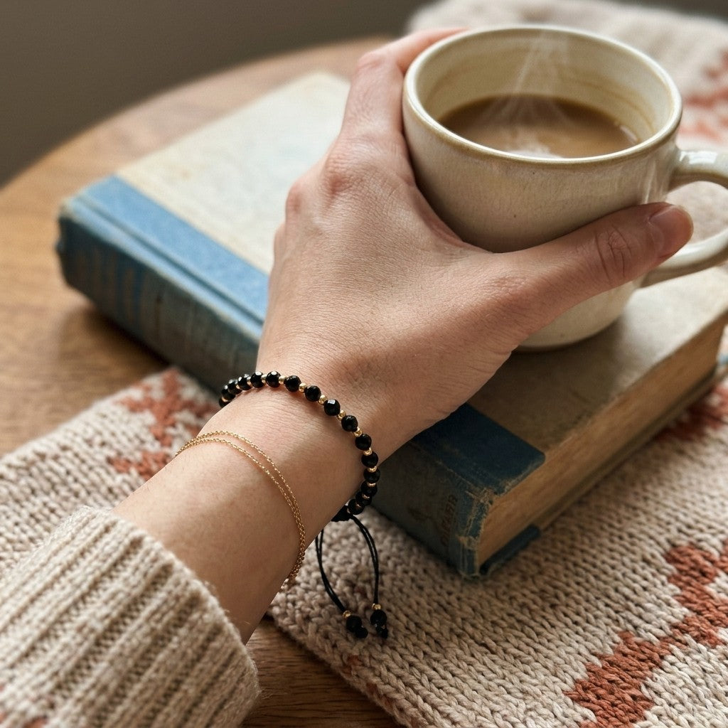 Adjustable Gold Black Beads Bracelet For Newborns and Adults (Worn on Wrist with Coffee Cup) | The Colourful Aura