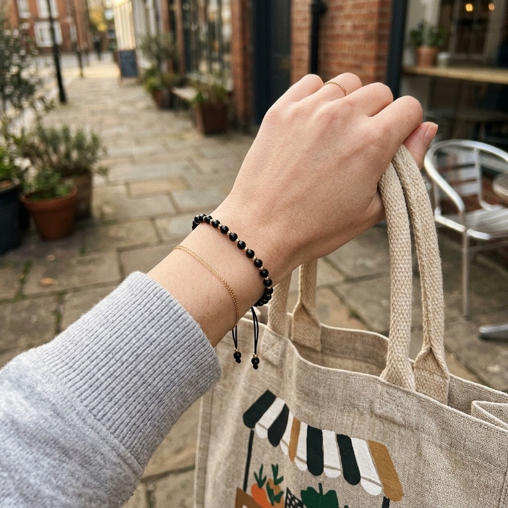Adjustable Gold Black Beads Bracelet For Newborns and Adults (Worn on Wrist with Tote Bag) | The Colourful Aura