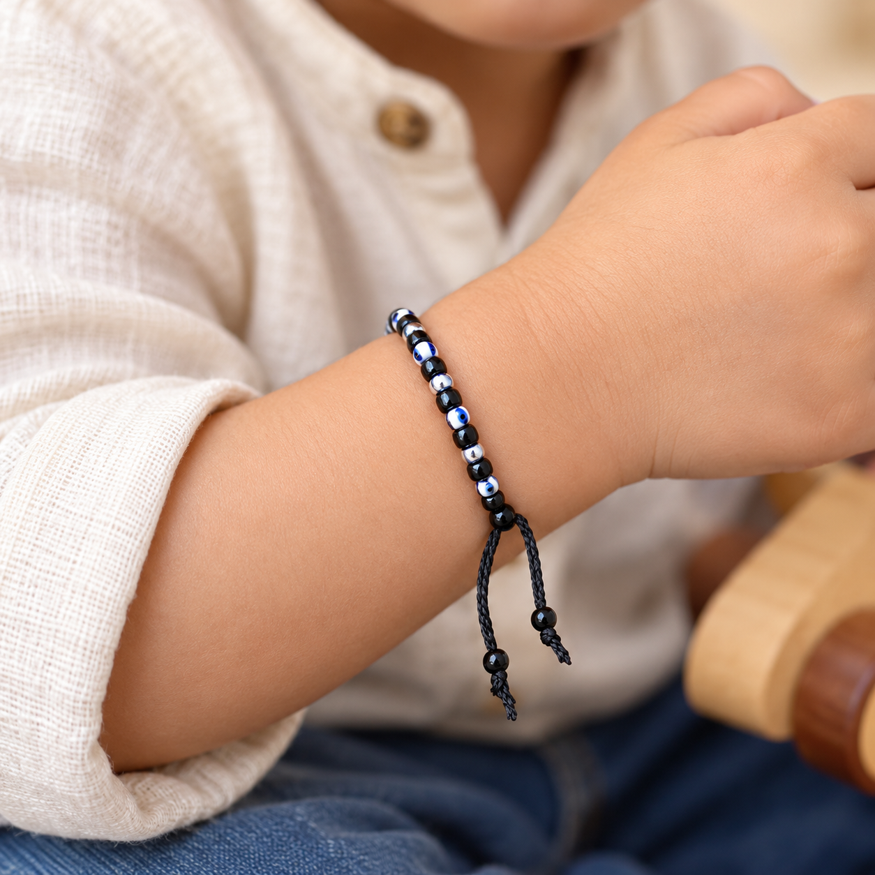 Adjustable Nylon Thread Black Beads Evil Eye Nazaria Bracelet for Kids and Babies (Close-up Detail) | The Colourful Aura