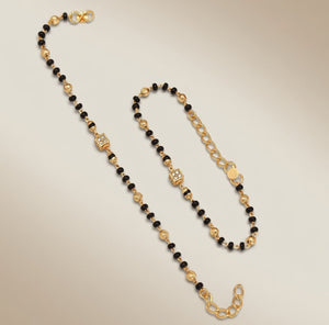 Baby Nazaria black bead gold bracelet flat lay showing full length infinity clasp and extension chain
