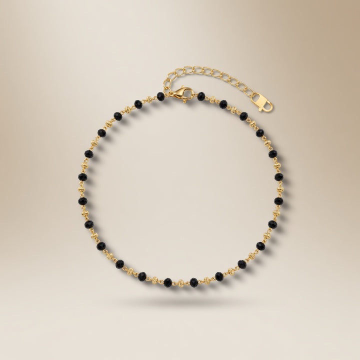 Black bead gold Nazaria anklet worn on ankle casual lifestyle shot 18k gold plated tarnish free The Colourful Aura