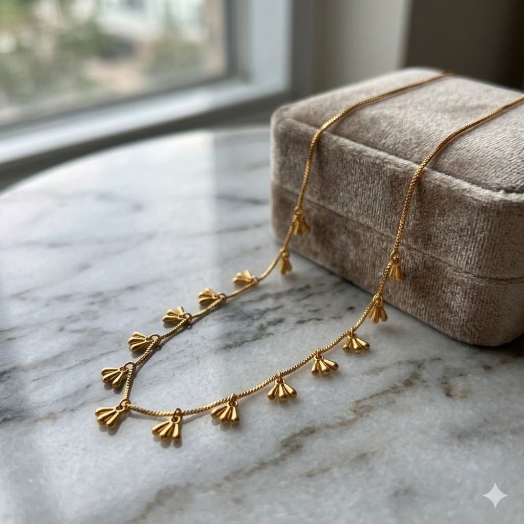 Gold fan charm drop necklace on marble surface — dainty boho jewellery UK
