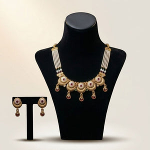 Gold meenakari disc choker necklace and circular drop earrings on velvet display — Asian bridal jewellery UK