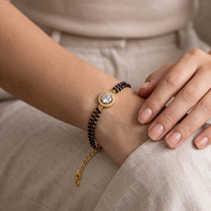 Gold Plated Black Bead Mangalsutra Bracelet with Round Charm (Close-up Detail) | The Colourful Aura