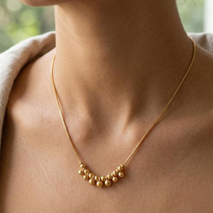18 inch gold plated graduated ball cluster necklace on model front view