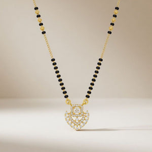 Gold plated CZ crystal heart mangalsutra on model wearing red saree front view