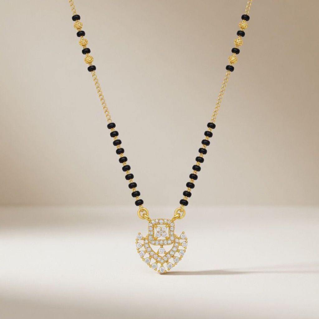 Gold plated CZ crystal heart mangalsutra on model wearing red saree front view