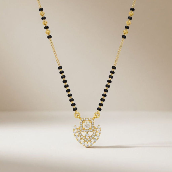 Gold plated CZ crystal heart mangalsutra on model wearing red saree front view