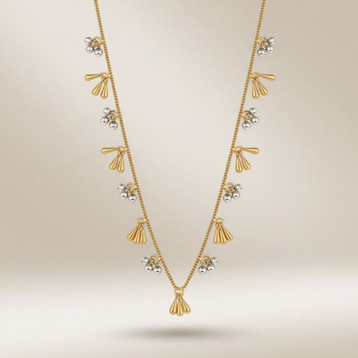 18 inch gold and silver dual tone tassel ball charm necklace worn by model front view