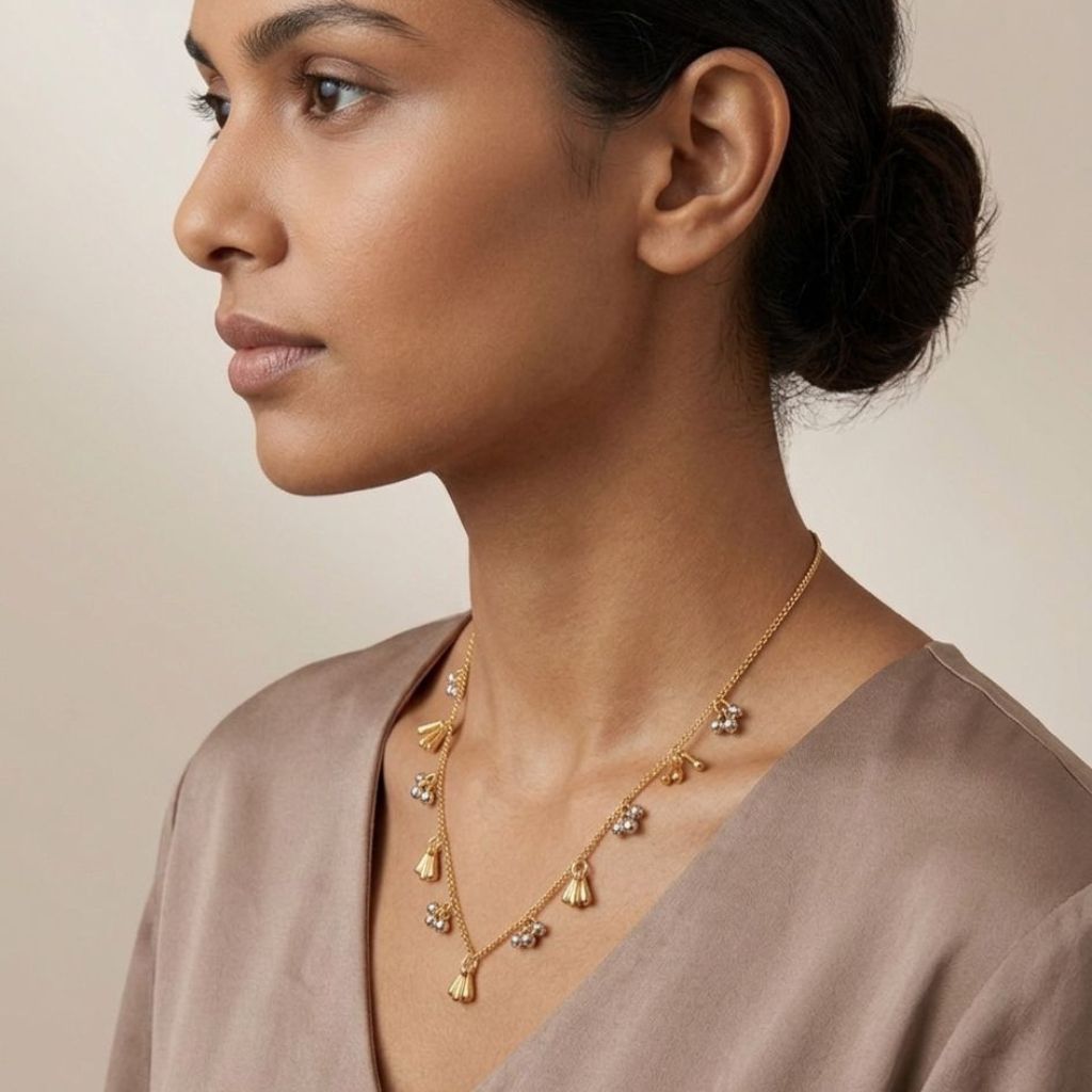Gold plated dual tone tassel and silver ball charm necklace flat lay product shot