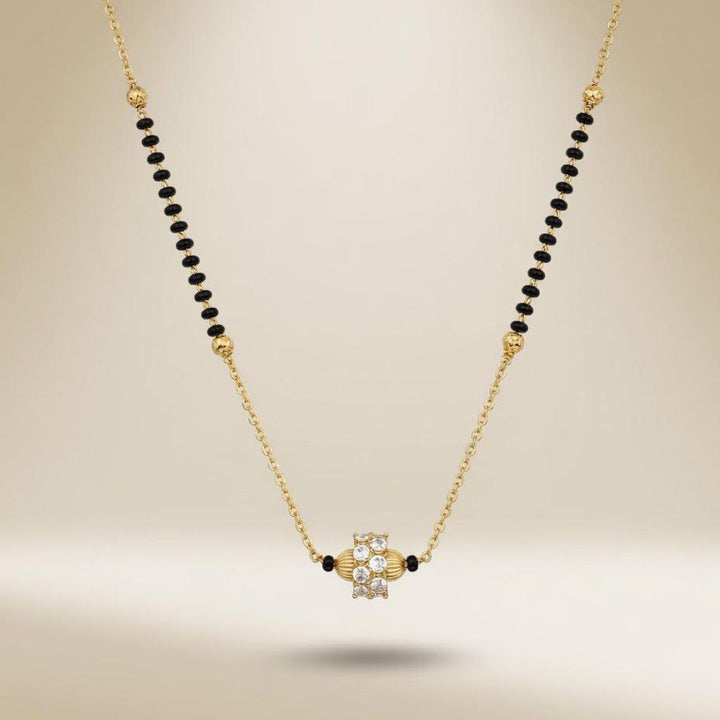 Gold plated mangalsutra necklace flat lay showing black beads gold accent beads and CZ crystal pendant