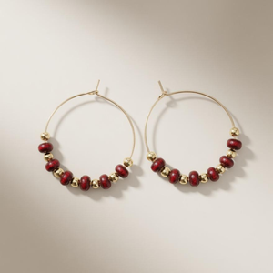 Pair of 30mm gold plated hoop earrings with red sandalwood and gold beads on a neutral background