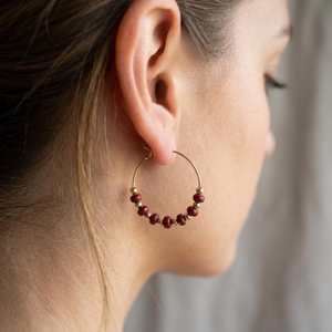 Close-up of a woman wearing red sandalwood and gold bead hoop earrings, 30mm gold plated alloy