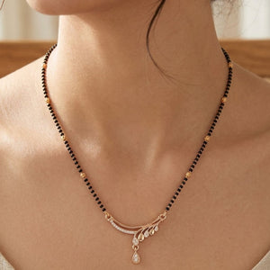 Rose gold plated mangalsutra with CZ crystal teardrop sweep pendant worn by model close up