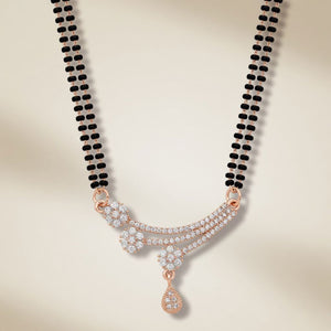 Rose gold plated double strand mangalsutra with CZ floral spray and teardrop pendant flat lay