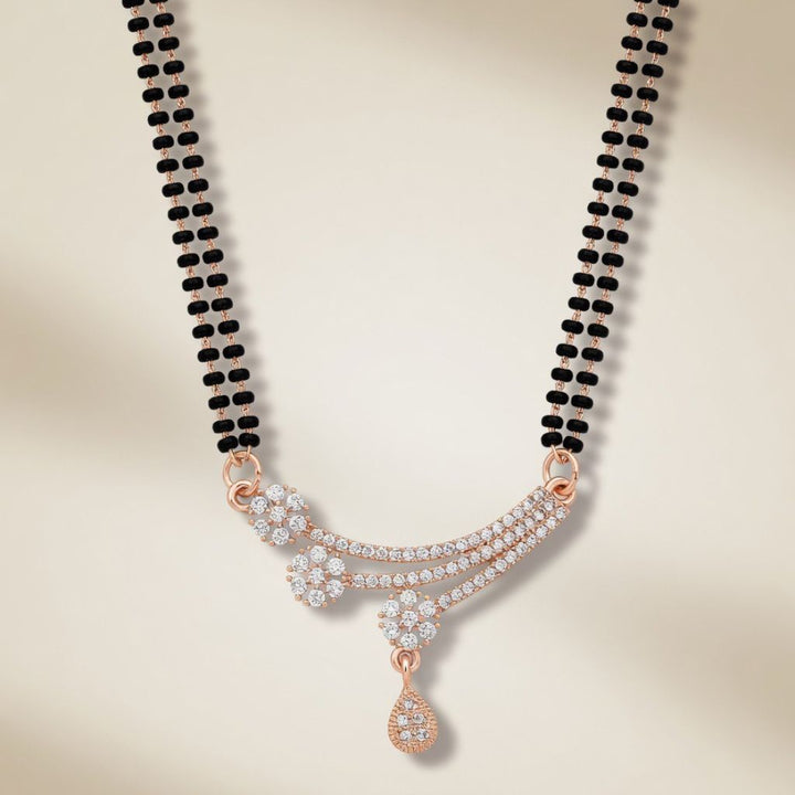 Rose gold plated double strand mangalsutra with CZ floral spray and teardrop pendant flat lay