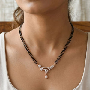 Rose gold double strand mangalsutra with CZ crystal floral spray pendant worn by model front view