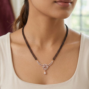 Rose gold double strand mangalsutra with CZ crystal floral wreath and teardrop pendant on model front view