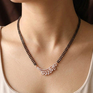 Rose gold plated double strand mangalsutra with CZ crystal wing leaf pendant worn by model close up
