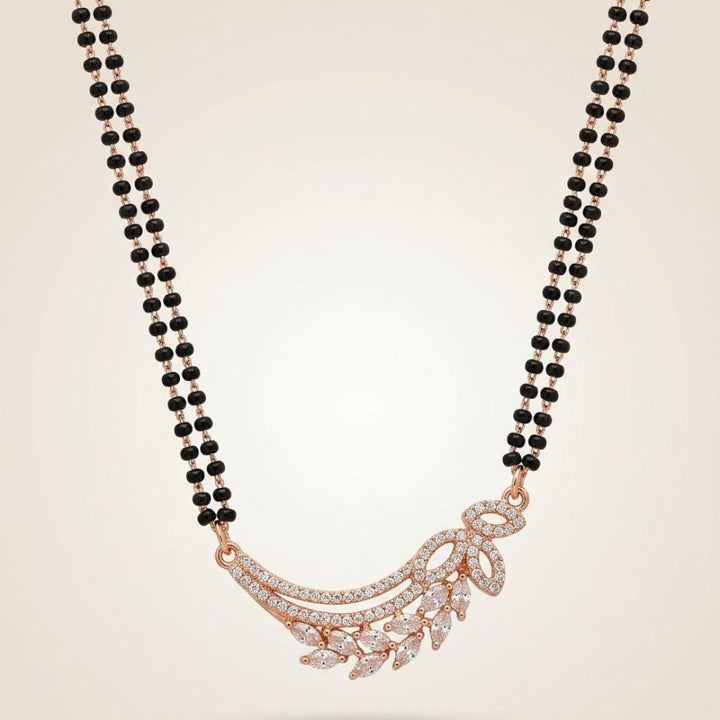 Rose gold plated double strand mangalsutra with CZ crystal wing and marquise leaf pendant flat lay