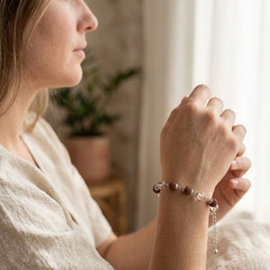 Close-up of a silver plated Rudraksha and crystal quartz bead bracelet worn on a woman's wrist