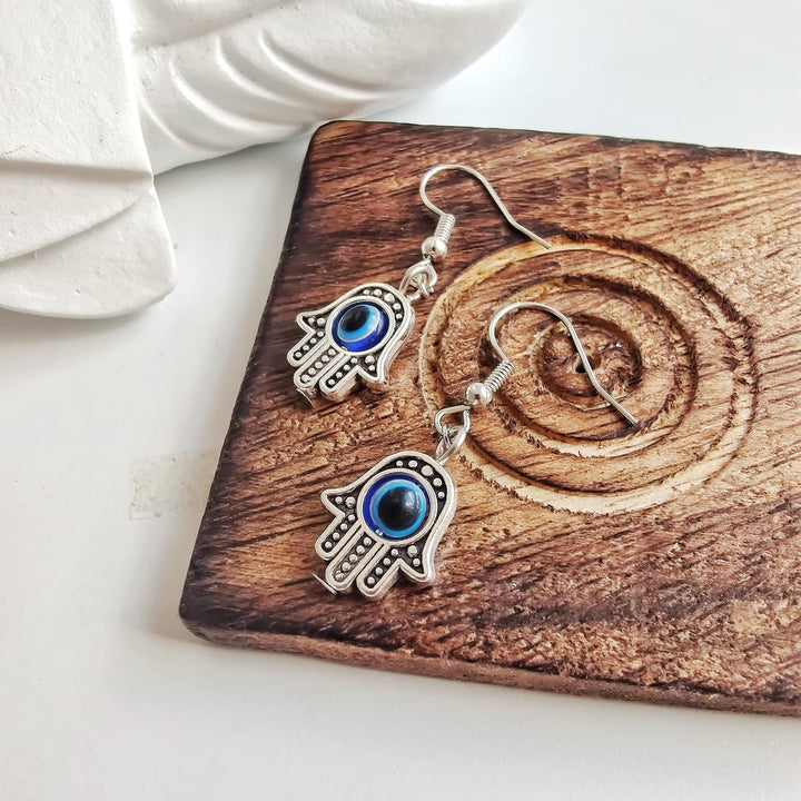 Silver Hamsa Protection Evil Eye Fatima Hand Charm Handmade Dangle Drop Earrings (Close-up Detail) | The Colourful Aura
